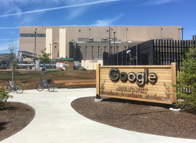 Exterior of Google's data center complex in The Dalles, Oregon, beneath a blue sky