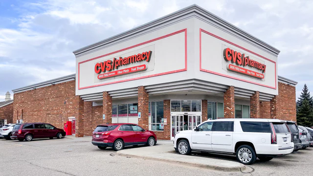Exterior of a CVS Pharmacy store with red CVS Pharmacy signage and no people in focus.
