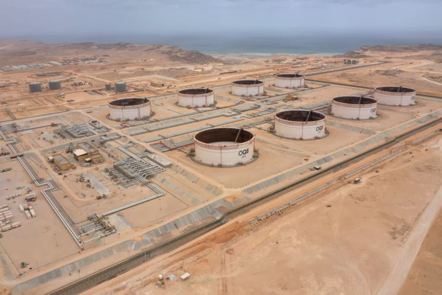 Aerial photograph of large circular oil-storage tanks at the Ras Markaz Oil Storage Park in the desert of Oman.