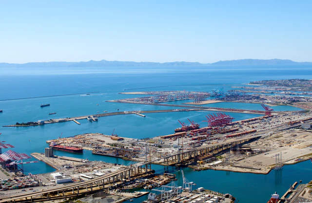 Aerial view of container terminals, cranes and cargo ships at the Port of Long Beach, California.