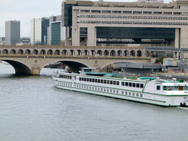 The modern French Ministry of the Economy and Finance building at Bercy in Paris, seen across the Seine behind the arched Pont de Bercy.